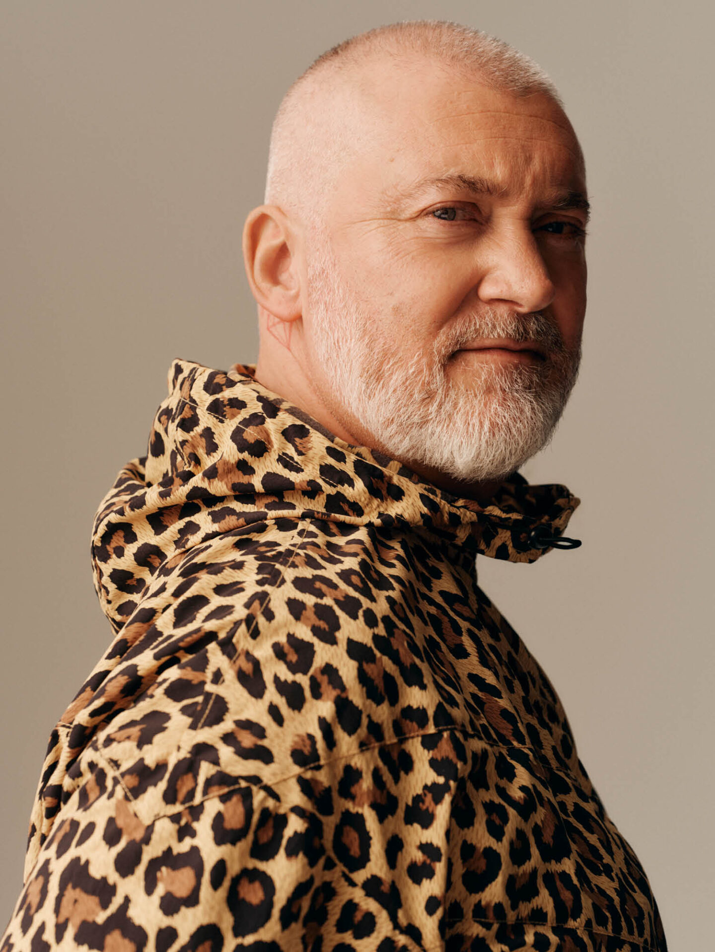 Logistics team member in a leopard-printed jacket, facing the camera.