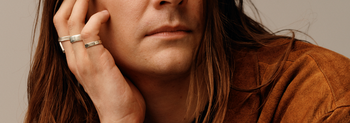 H&M colleague is leaning their face at their hands.