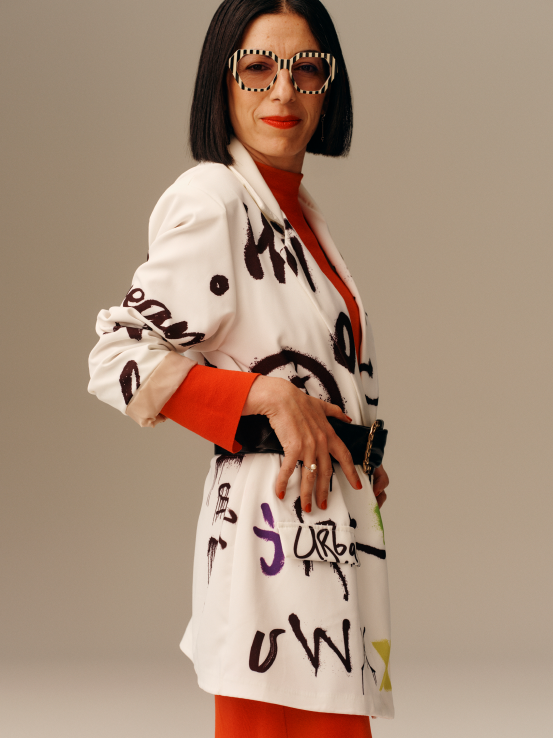 Female leader in a blazer with prints, related to content about sustainability.