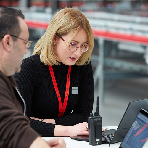 Portrait of an H&M team leader wearing a red band.