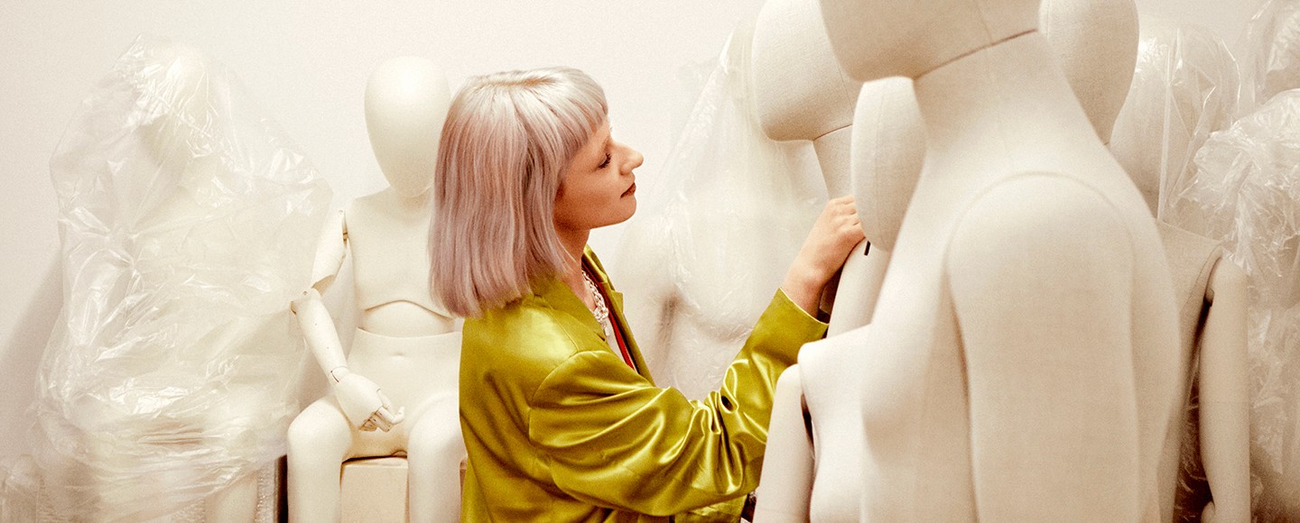 Woman selecting a mannequin from a storage room
